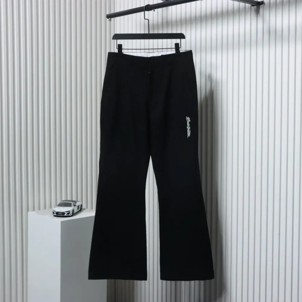 Flared trousers with embroidered lettering back pocket patches